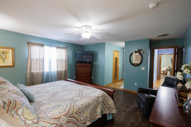 bedroom with a ceiling fan, wood finished floors, visible vents, and baseboards