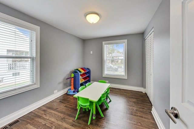 game room featuring dark wood-type flooring