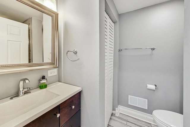 bathroom with vanity and toilet