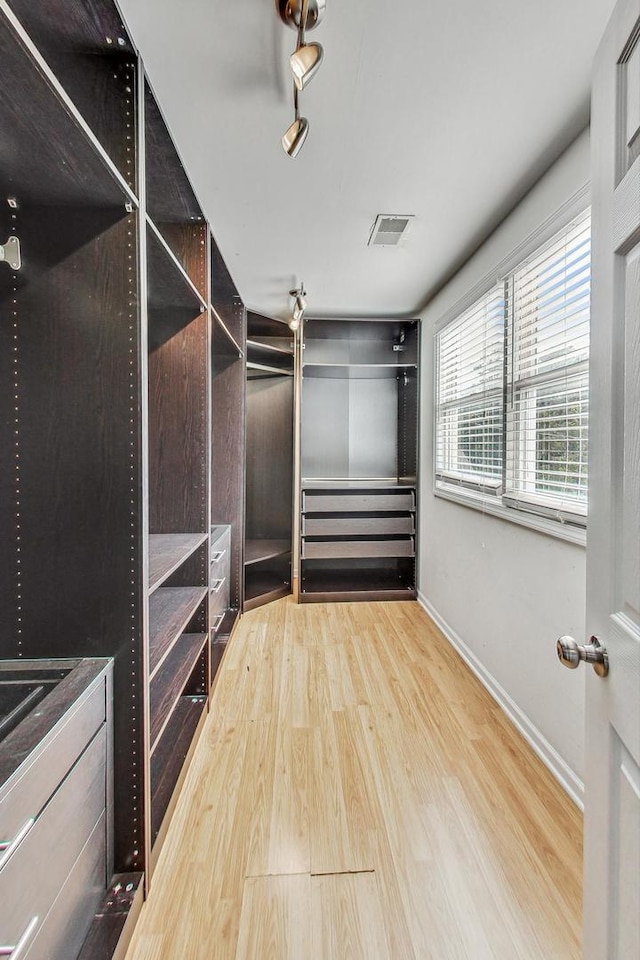 spacious closet featuring light wood-type flooring