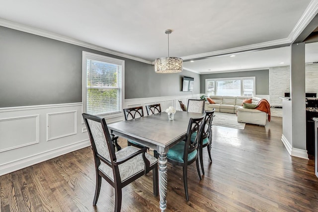 dining space with crown molding and dark wood-type flooring