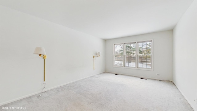 unfurnished room featuring light colored carpet