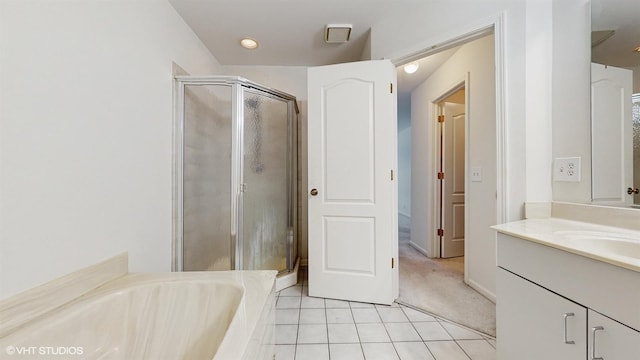 bathroom featuring tile patterned flooring, vanity, and independent shower and bath