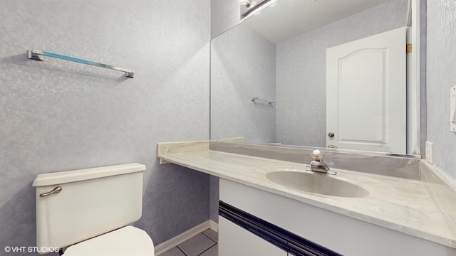 bathroom featuring tile patterned floors, vanity, and toilet