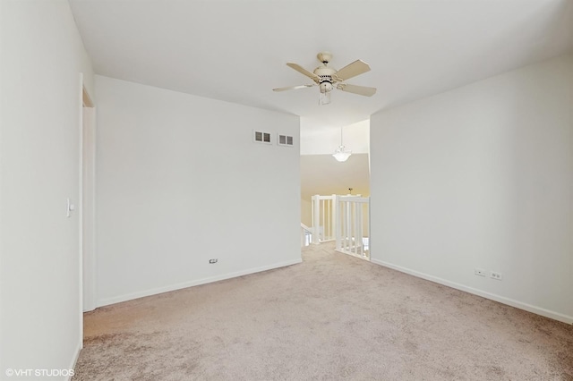 carpeted spare room featuring ceiling fan