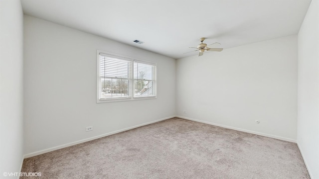 spare room with light carpet and ceiling fan