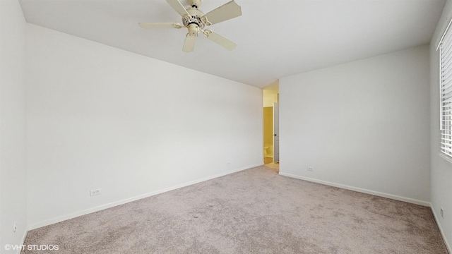 empty room with ceiling fan and light colored carpet