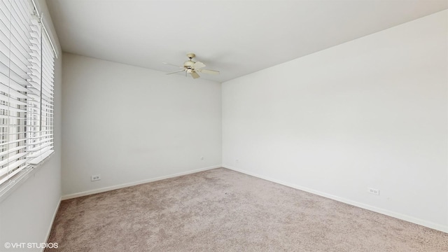 unfurnished room with ceiling fan and light carpet