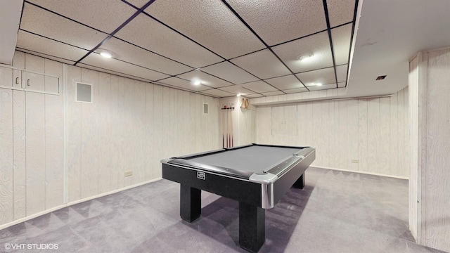 recreation room featuring carpet floors, a drop ceiling, wood walls, and billiards