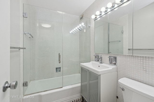 full bathroom with vanity, decorative backsplash, toilet, enclosed tub / shower combo, and tile walls