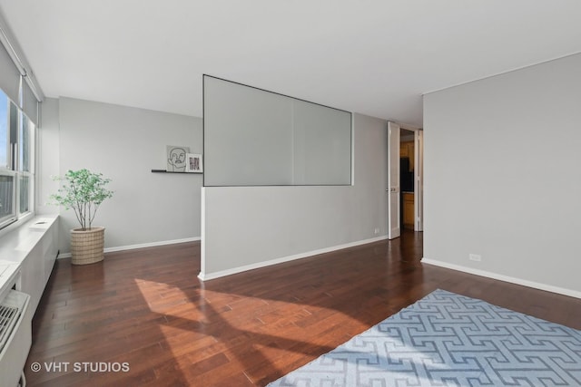 empty room with dark hardwood / wood-style floors