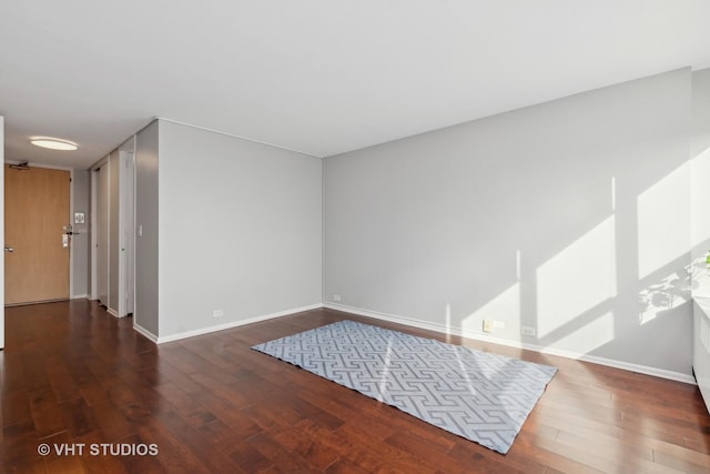 spare room featuring dark wood-type flooring