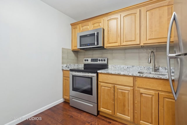 kitchen featuring light stone countertops, backsplash, stainless steel appliances, and dark hardwood / wood-style floors