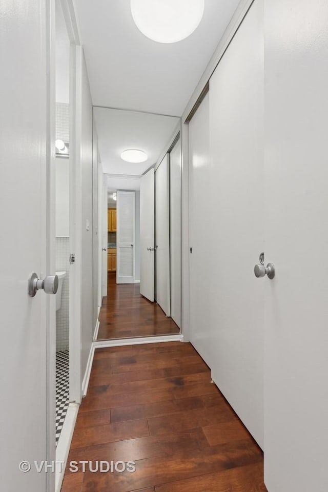 corridor with dark hardwood / wood-style floors