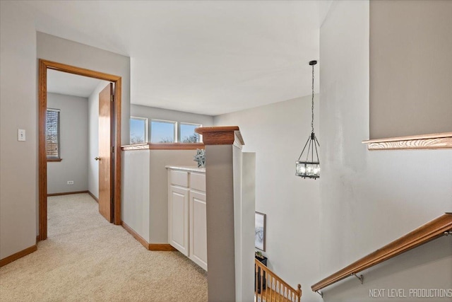 hall featuring light colored carpet