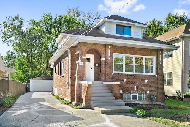 view of front of property with a garage and an outdoor structure