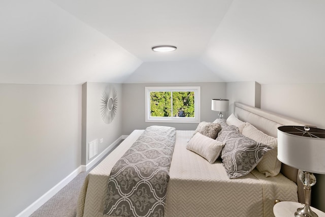 carpeted bedroom featuring lofted ceiling