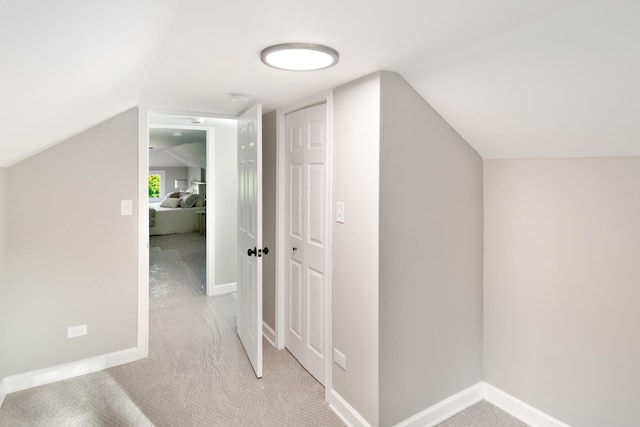 bonus room featuring light colored carpet and vaulted ceiling