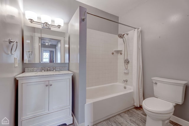 full bathroom featuring hardwood / wood-style flooring, vanity, toilet, and shower / bath combo with shower curtain