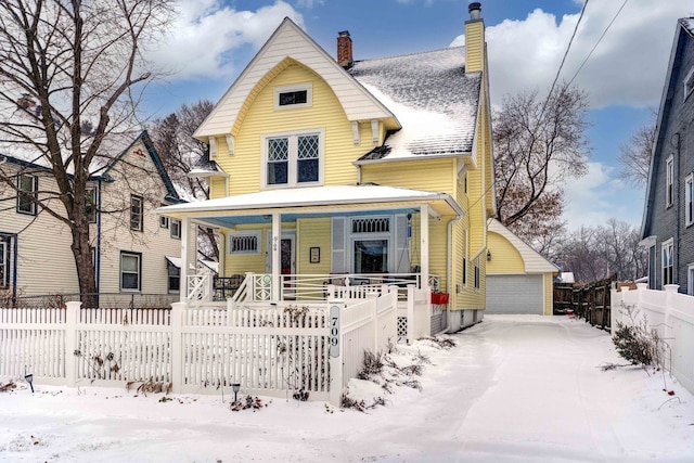 view of front of property with a garage, an outbuilding, and covered porch