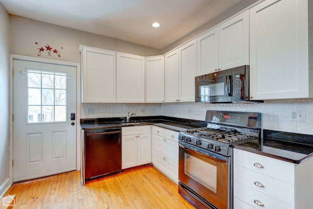 kitchen with white cabinetry, sink, light hardwood / wood-style flooring, and black appliances