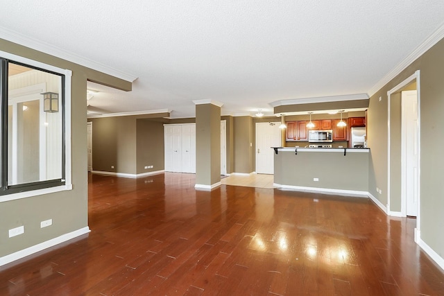 unfurnished living room featuring hardwood / wood-style flooring, crown molding, and a textured ceiling