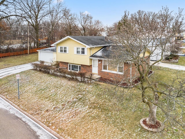 tri-level home with a front lawn