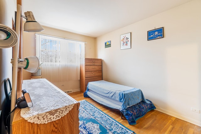 bedroom with hardwood / wood-style floors