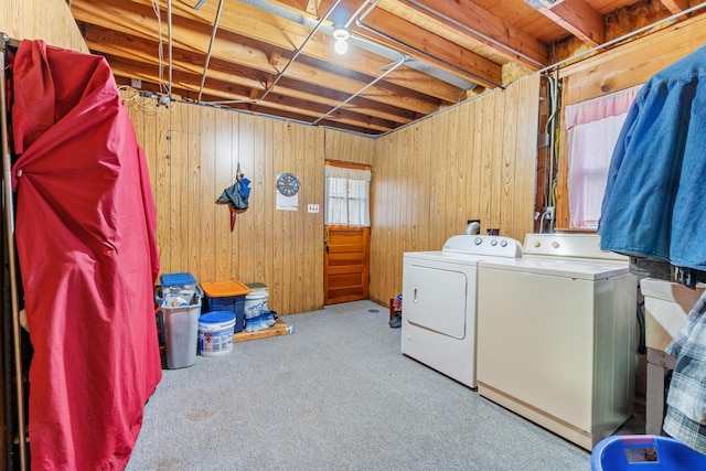 washroom with washer and dryer, carpet, and wood walls