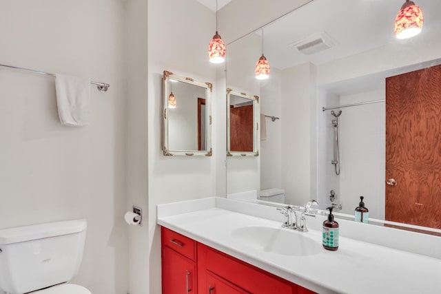 bathroom with vanity, toilet, and walk in shower