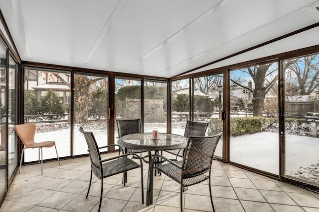 unfurnished sunroom with lofted ceiling