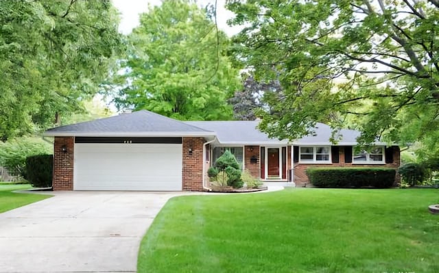 ranch-style house featuring a front lawn and a garage