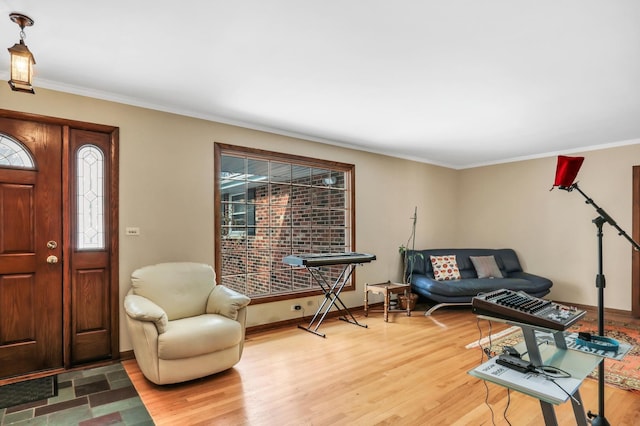 interior space featuring a wealth of natural light, light hardwood / wood-style flooring, and ornamental molding