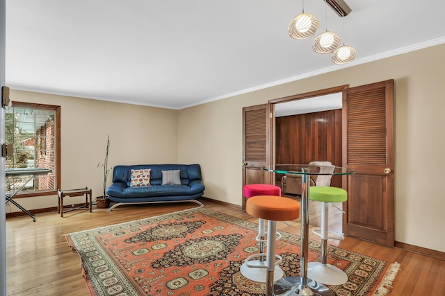 living room featuring crown molding and light hardwood / wood-style floors