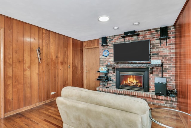 living room featuring wood walls and hardwood / wood-style flooring