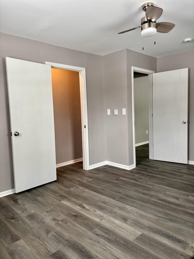 unfurnished bedroom featuring dark hardwood / wood-style flooring, ceiling fan, and a closet