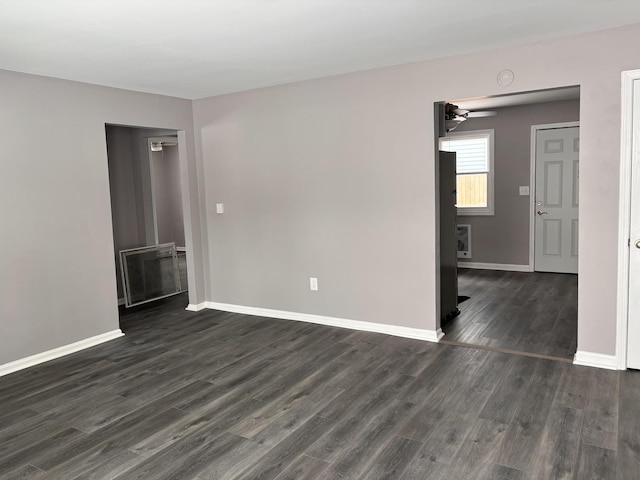 spare room featuring ceiling fan and dark hardwood / wood-style flooring