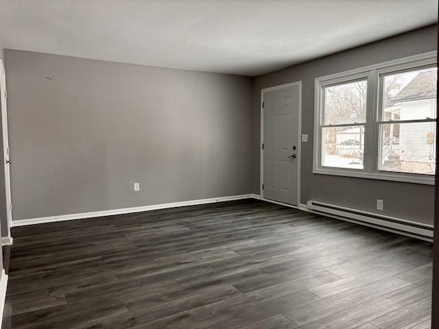 interior space featuring baseboard heating and dark hardwood / wood-style flooring