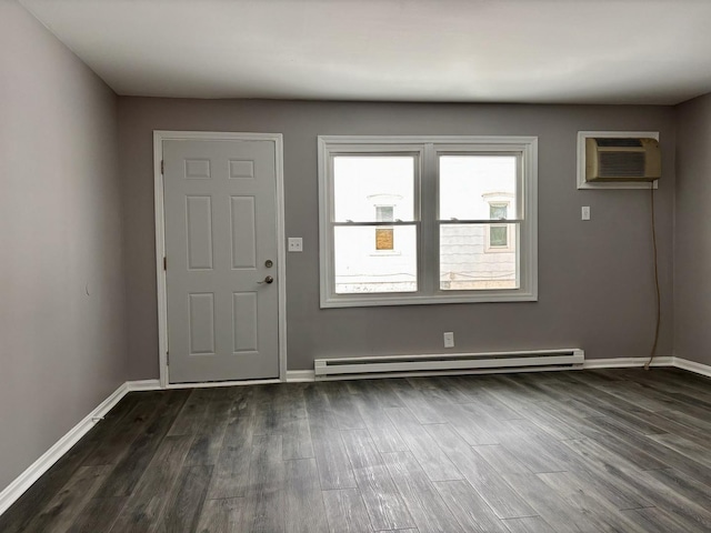 entrance foyer with dark hardwood / wood-style floors, an AC wall unit, and baseboard heating