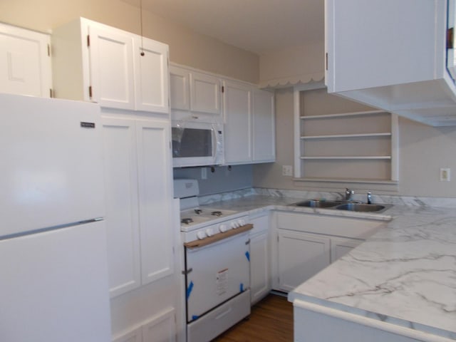 kitchen featuring white cabinetry, sink, light stone countertops, dark hardwood / wood-style flooring, and white appliances