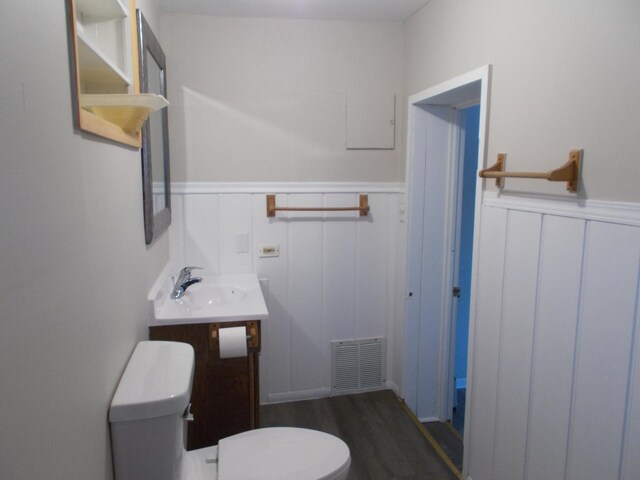 bathroom featuring hardwood / wood-style floors, vanity, and toilet