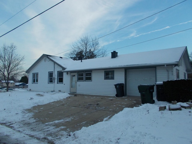 snow covered property featuring a garage