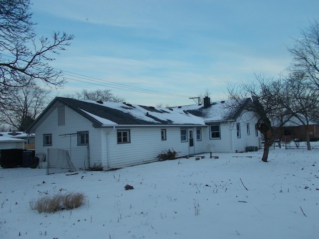 view of snow covered rear of property