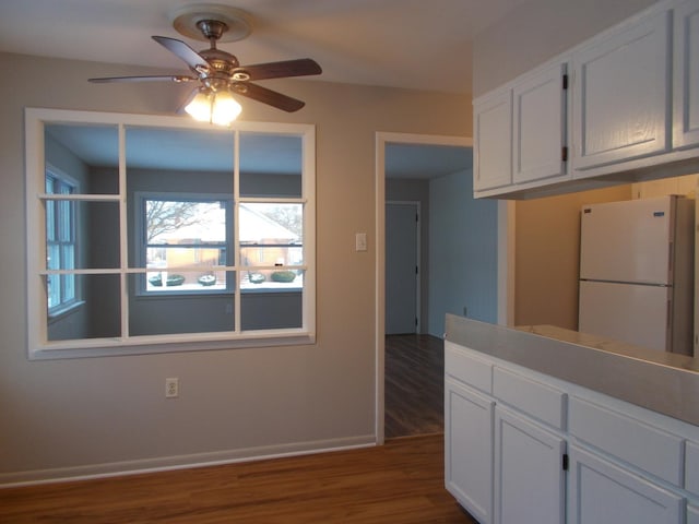 kitchen featuring white cabinets, ceiling fan, white fridge, and dark hardwood / wood-style floors