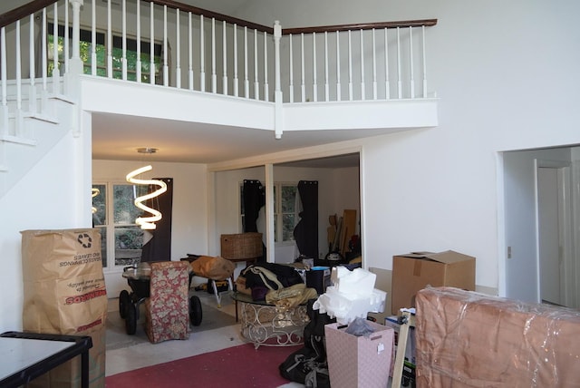 living room featuring a high ceiling and a chandelier