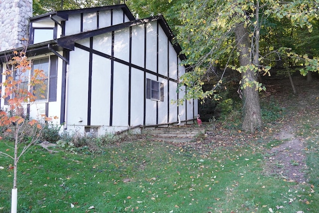 view of side of property with a lawn