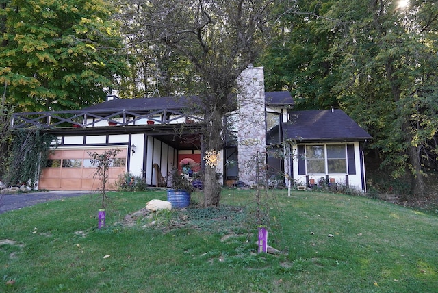 view of front of home with a front lawn and a garage