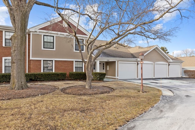 view of front of house featuring a garage and a front lawn