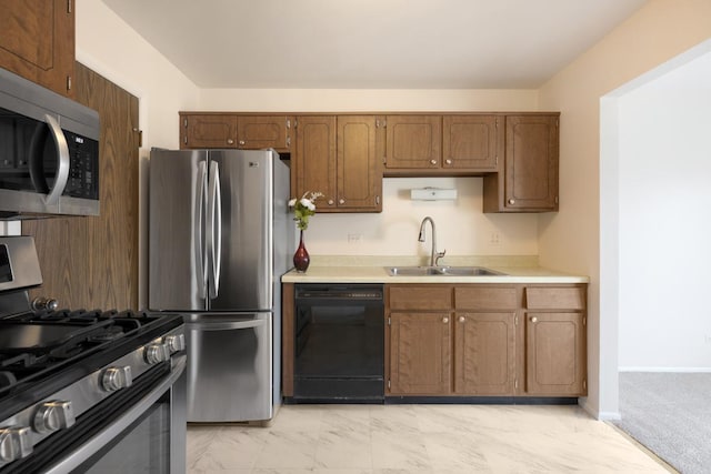 kitchen with light colored carpet, sink, and appliances with stainless steel finishes