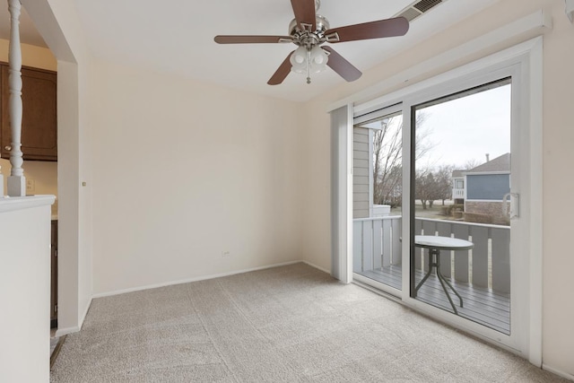 carpeted spare room featuring ceiling fan